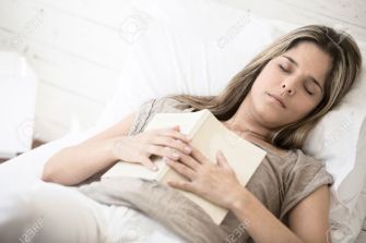 19193944-Woman-falling-asleep-while-reading-a-book-in-bed-Stock-Photo.jpg
